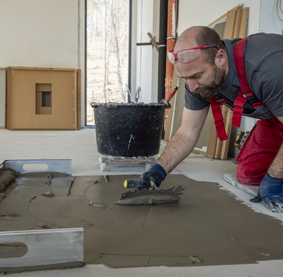 Construction worker leveling floor cement
