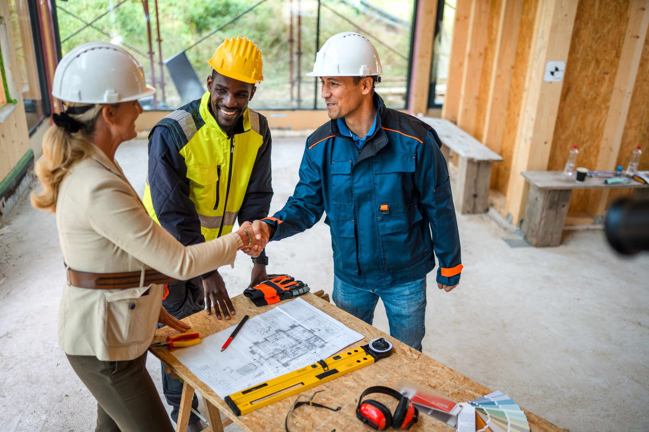 Engineers collaborating on project blueprint