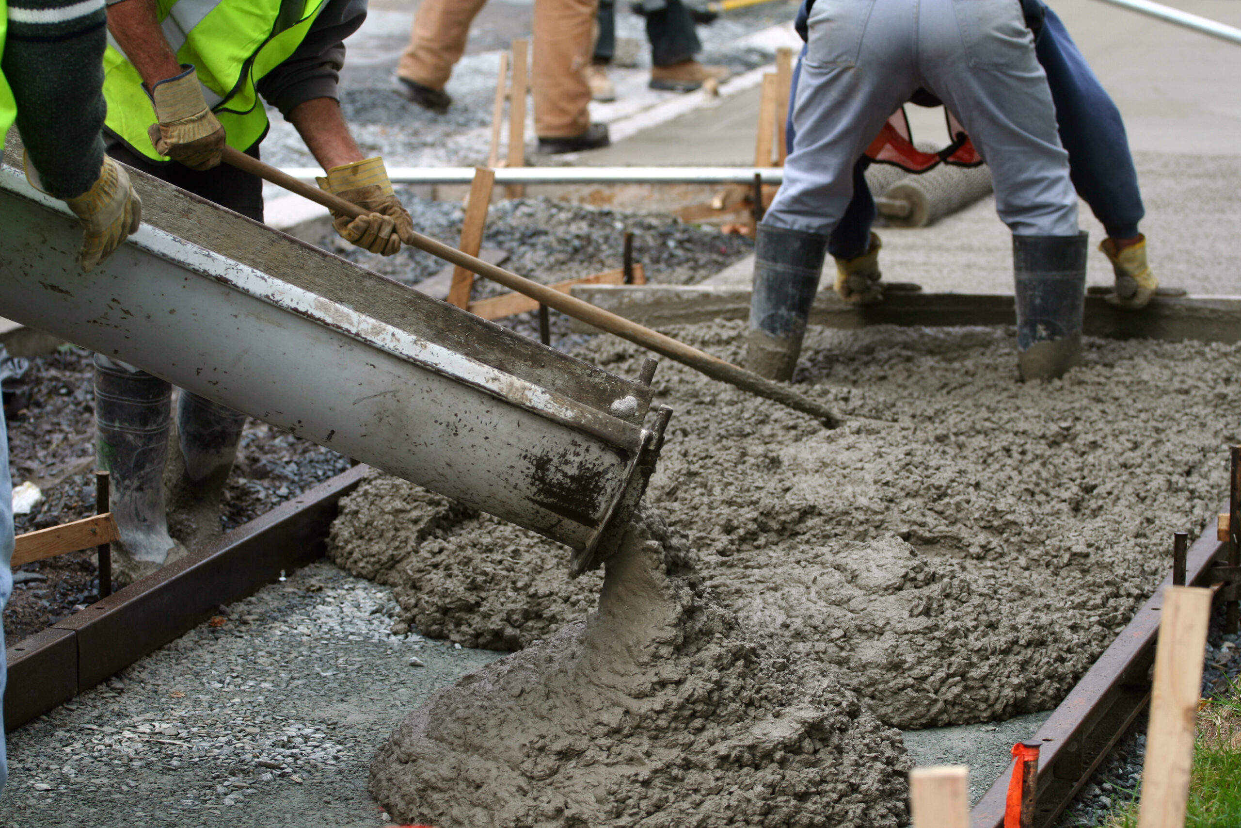 Team installing new concrete pavement