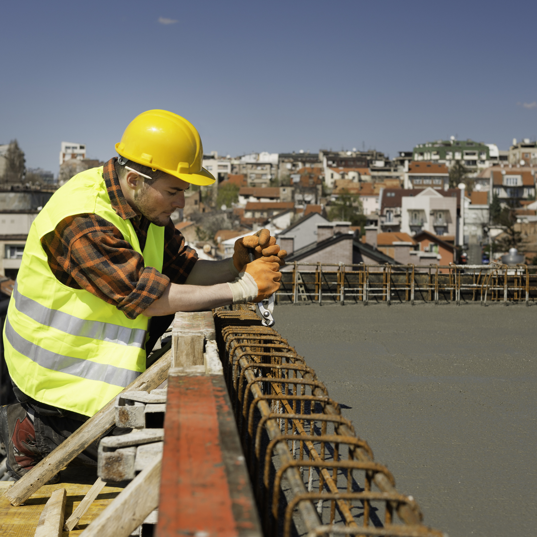 Man tightening bolts on construction framework