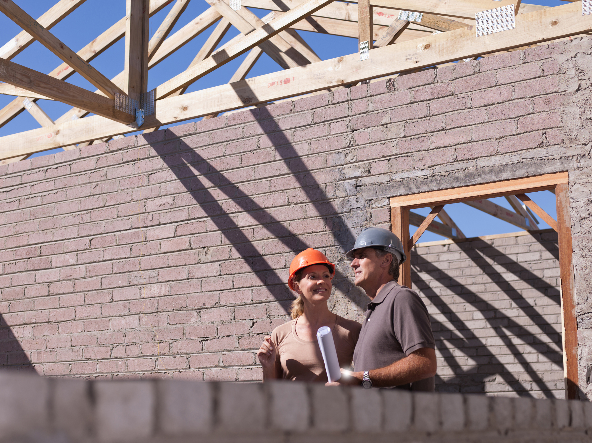 Construction workers discussing building plans