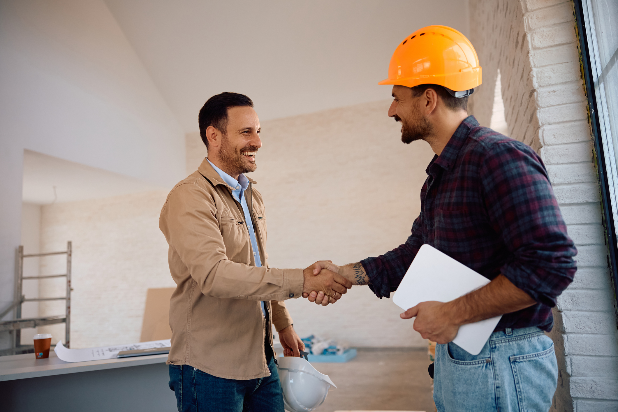 Construction workers shaking hands in agreement