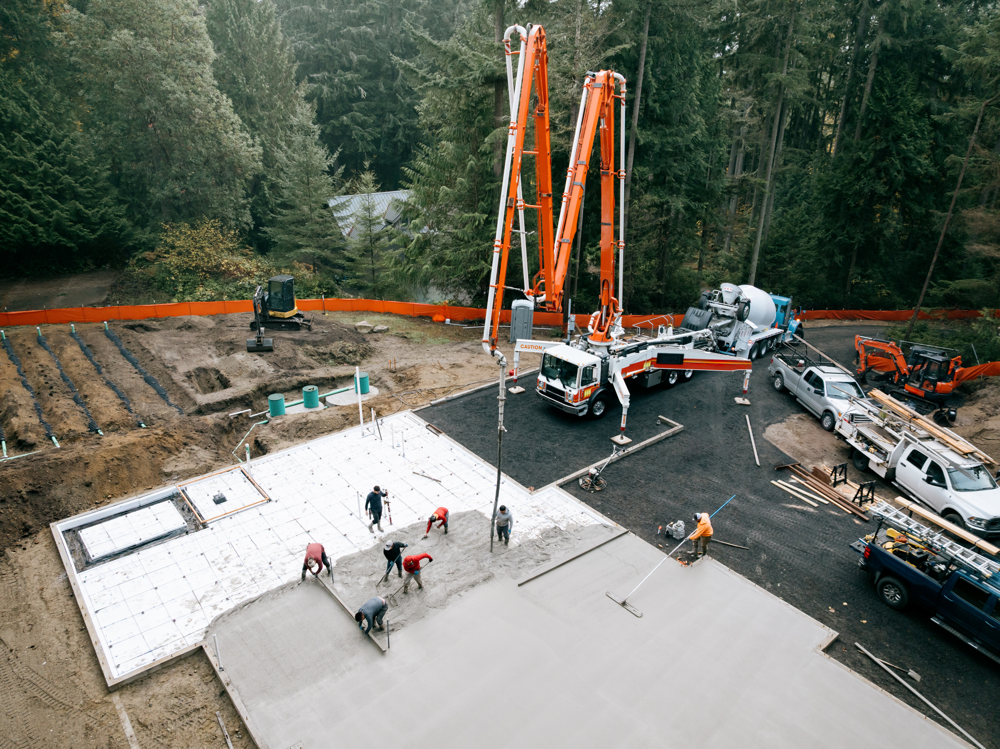 Construction workers pouring concrete slab