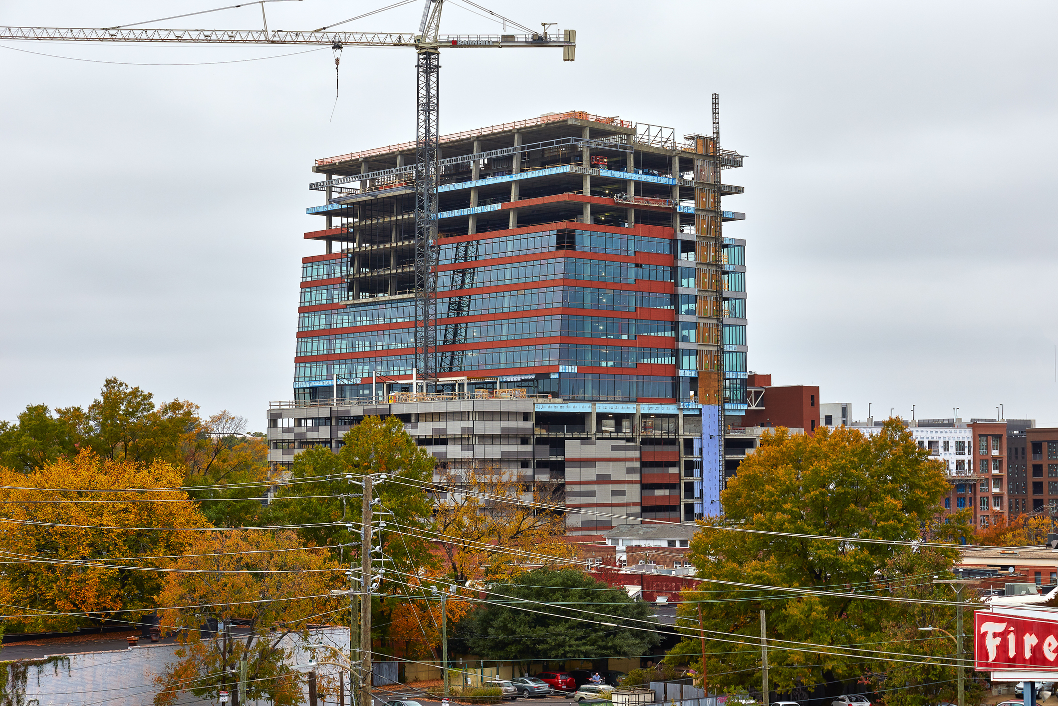 Urban development with cranes and autumn trees