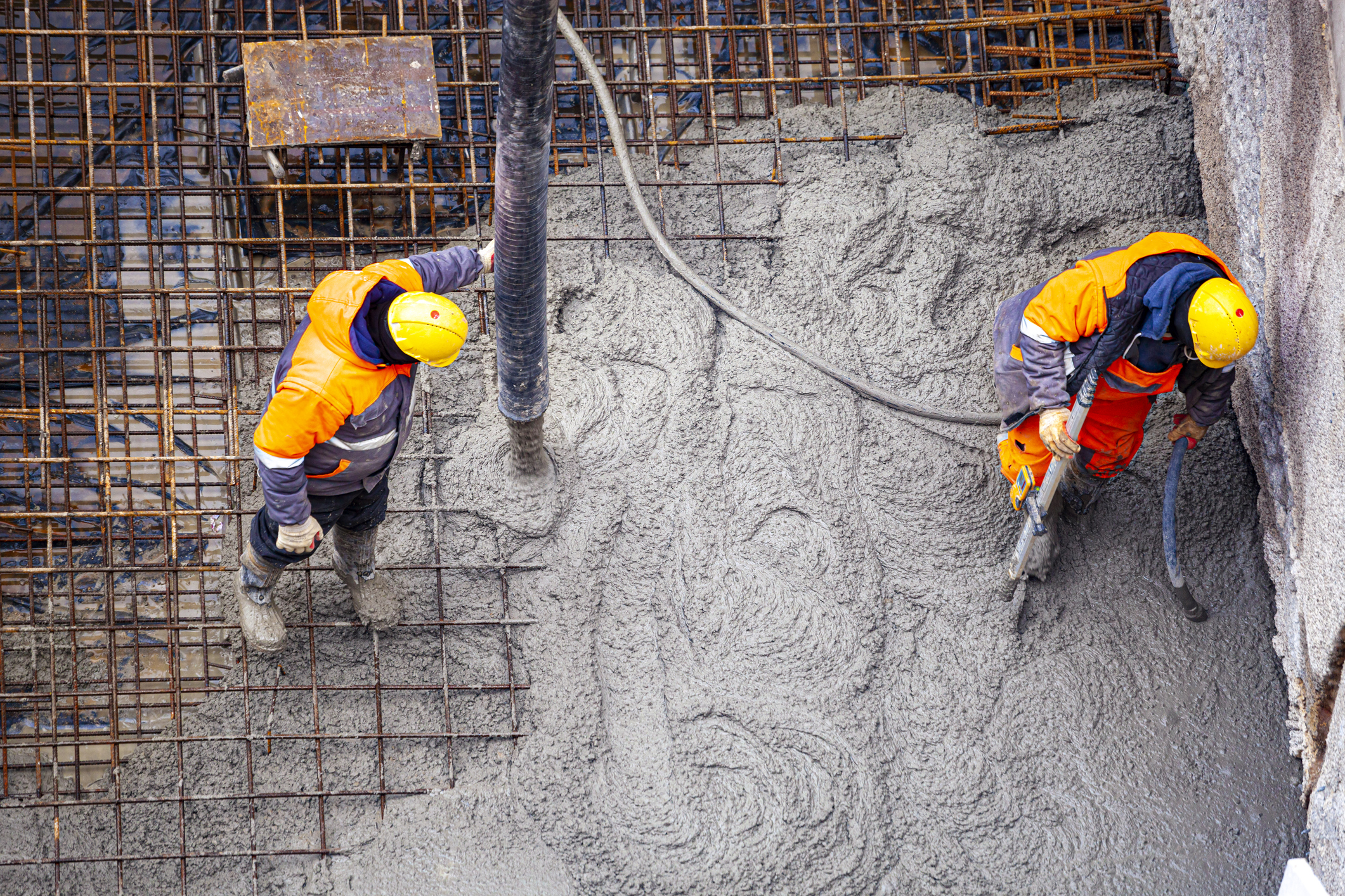Workers pouring concrete