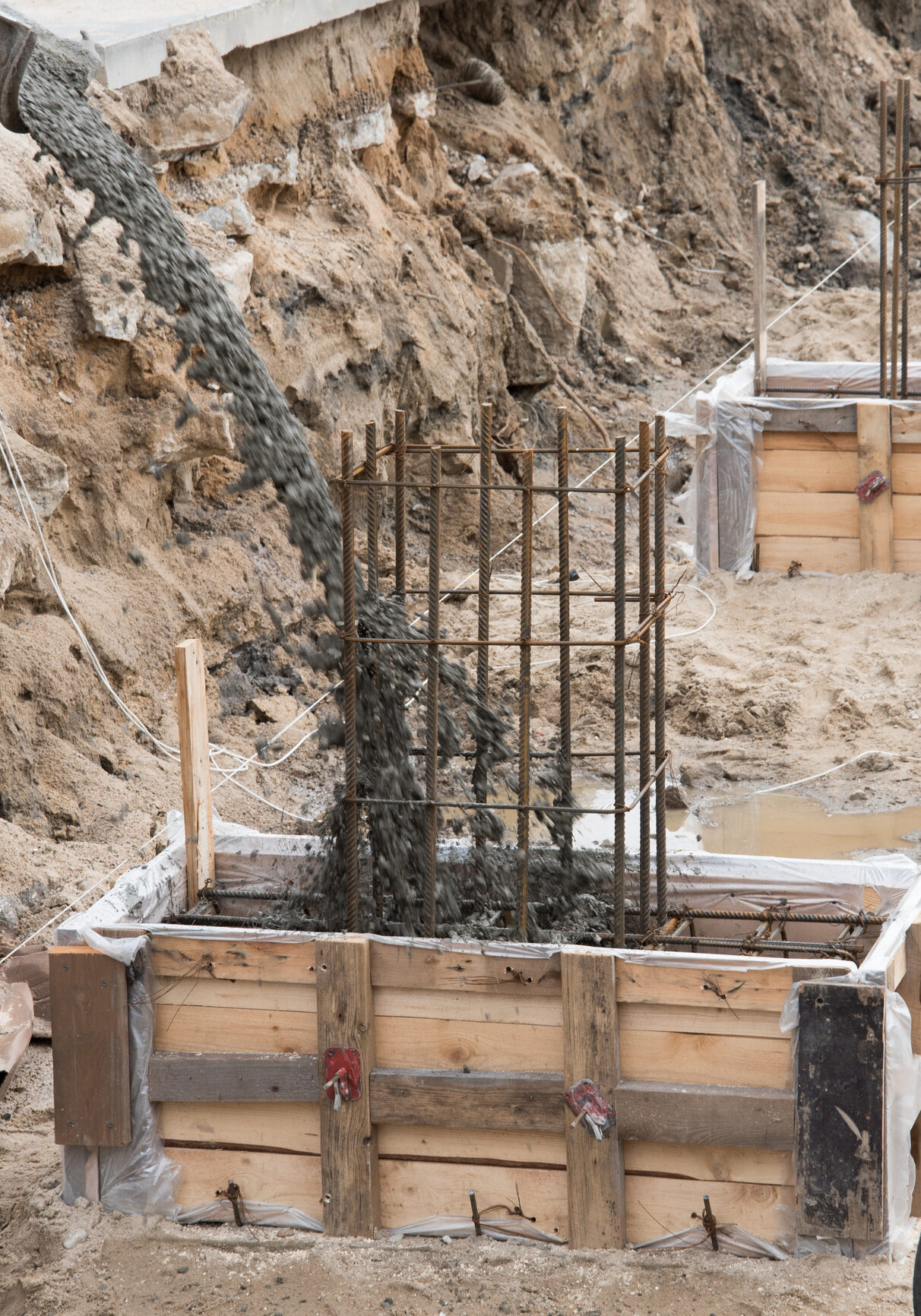 Concrete being poured into foundation mold