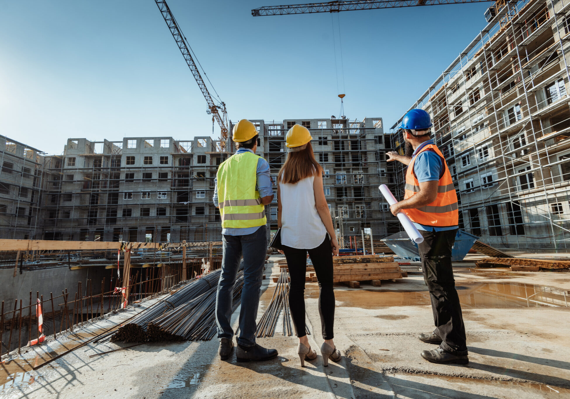Construction workers discussing building plans on site