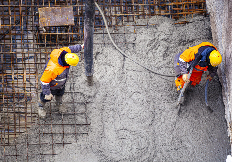 Workers pouring concrete