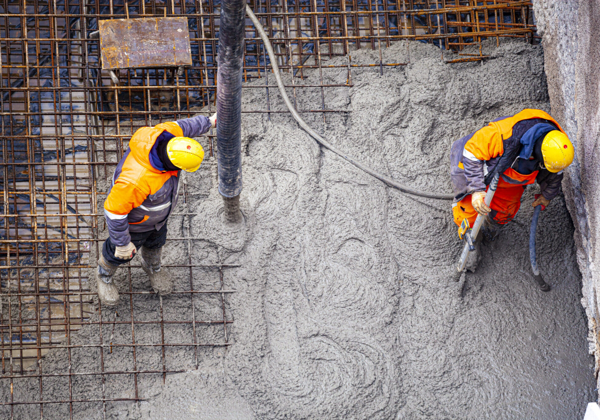 Workers pouring concrete
