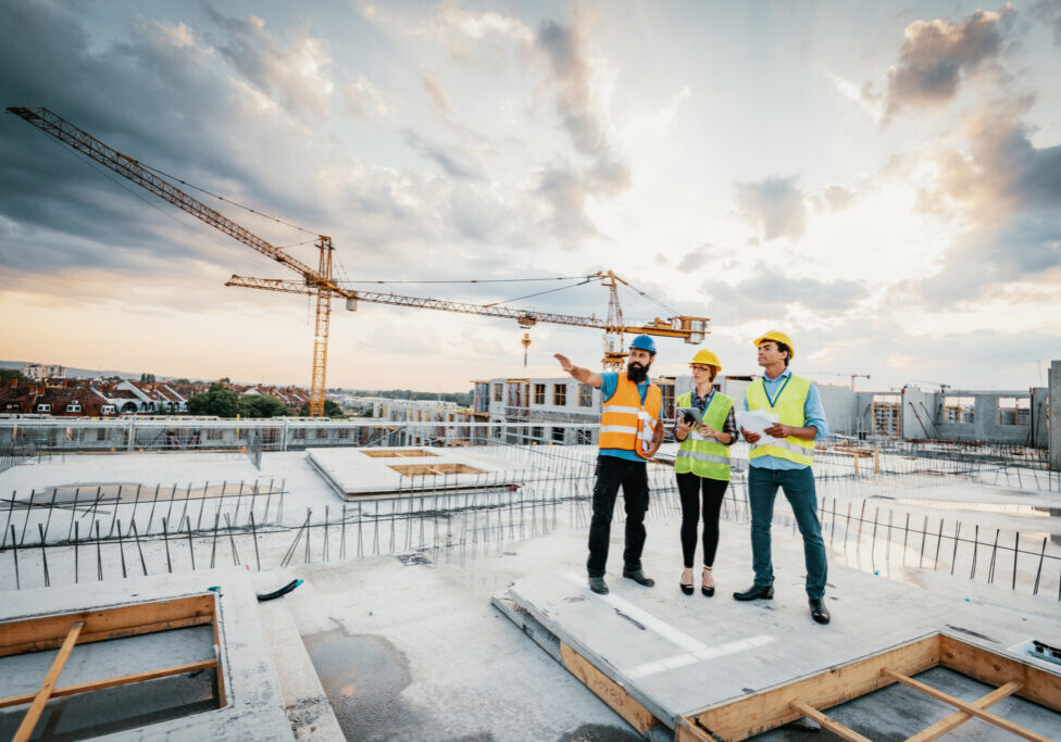 Construction team reviewing building plans