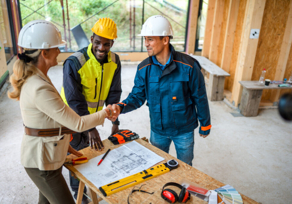Engineers collaborating on project blueprint