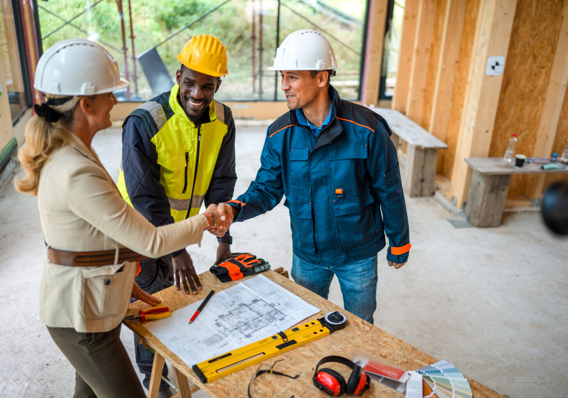 Engineers collaborating on project blueprint