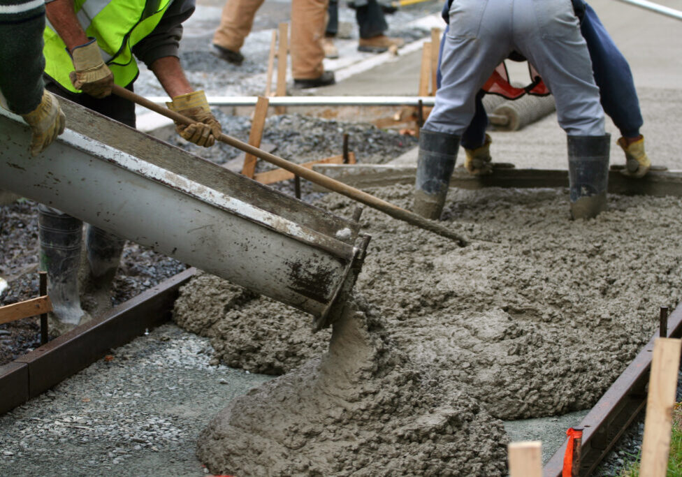 Team installing new concrete pavement