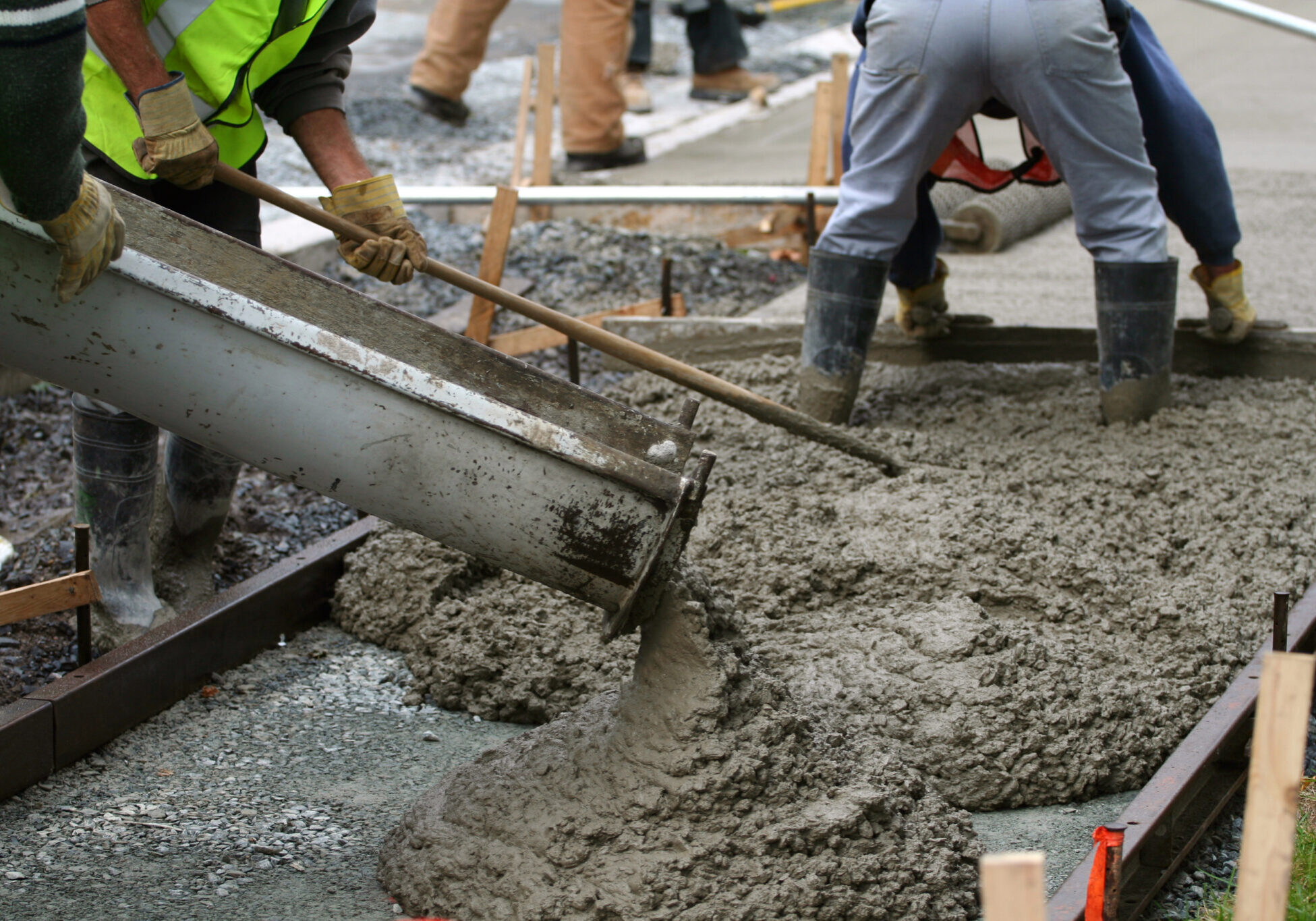 Team installing new concrete pavement