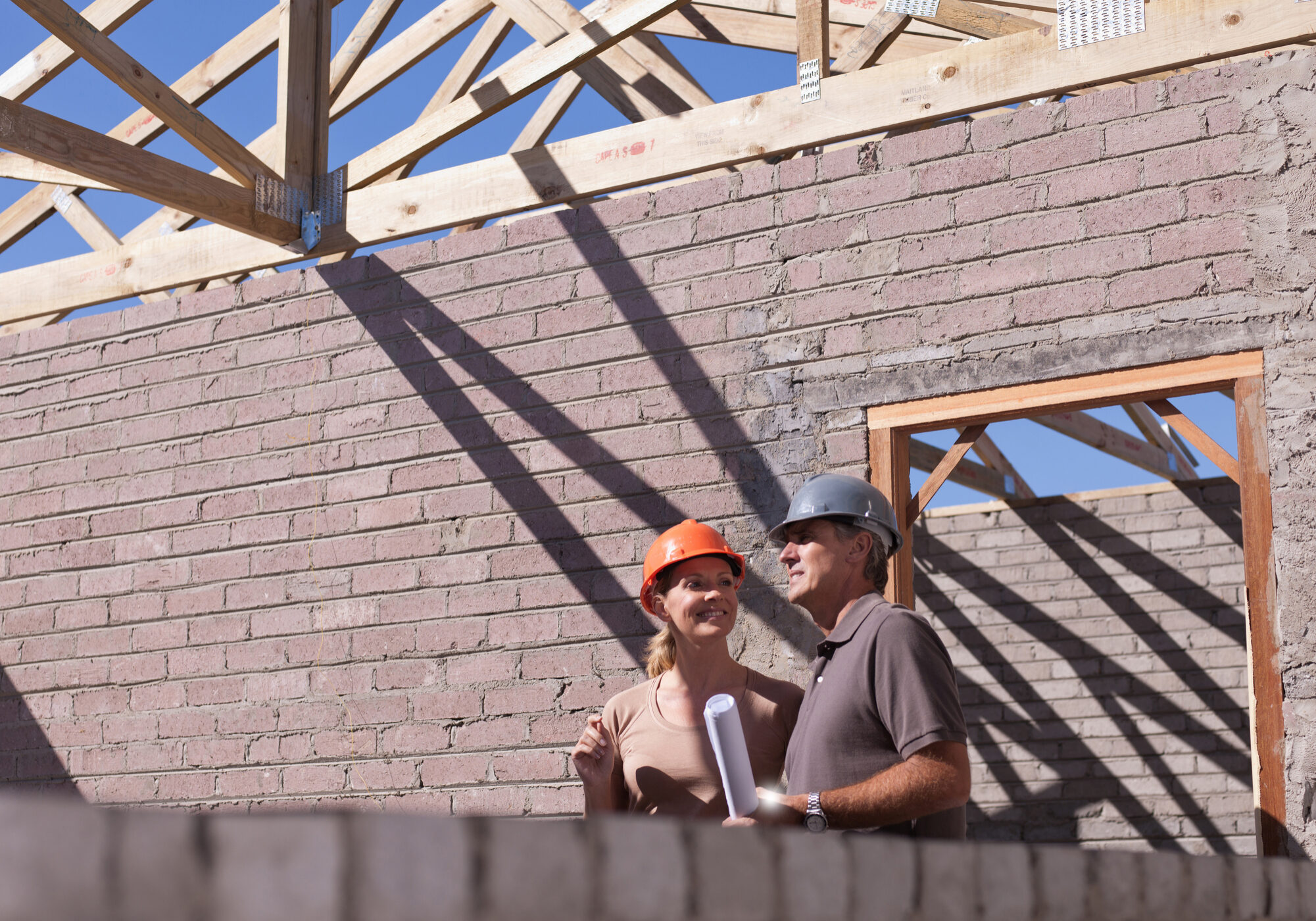 Construction workers discussing building plans