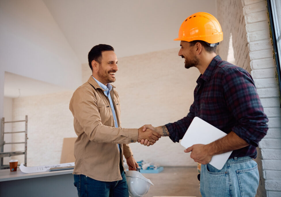 Construction workers shaking hands in agreement