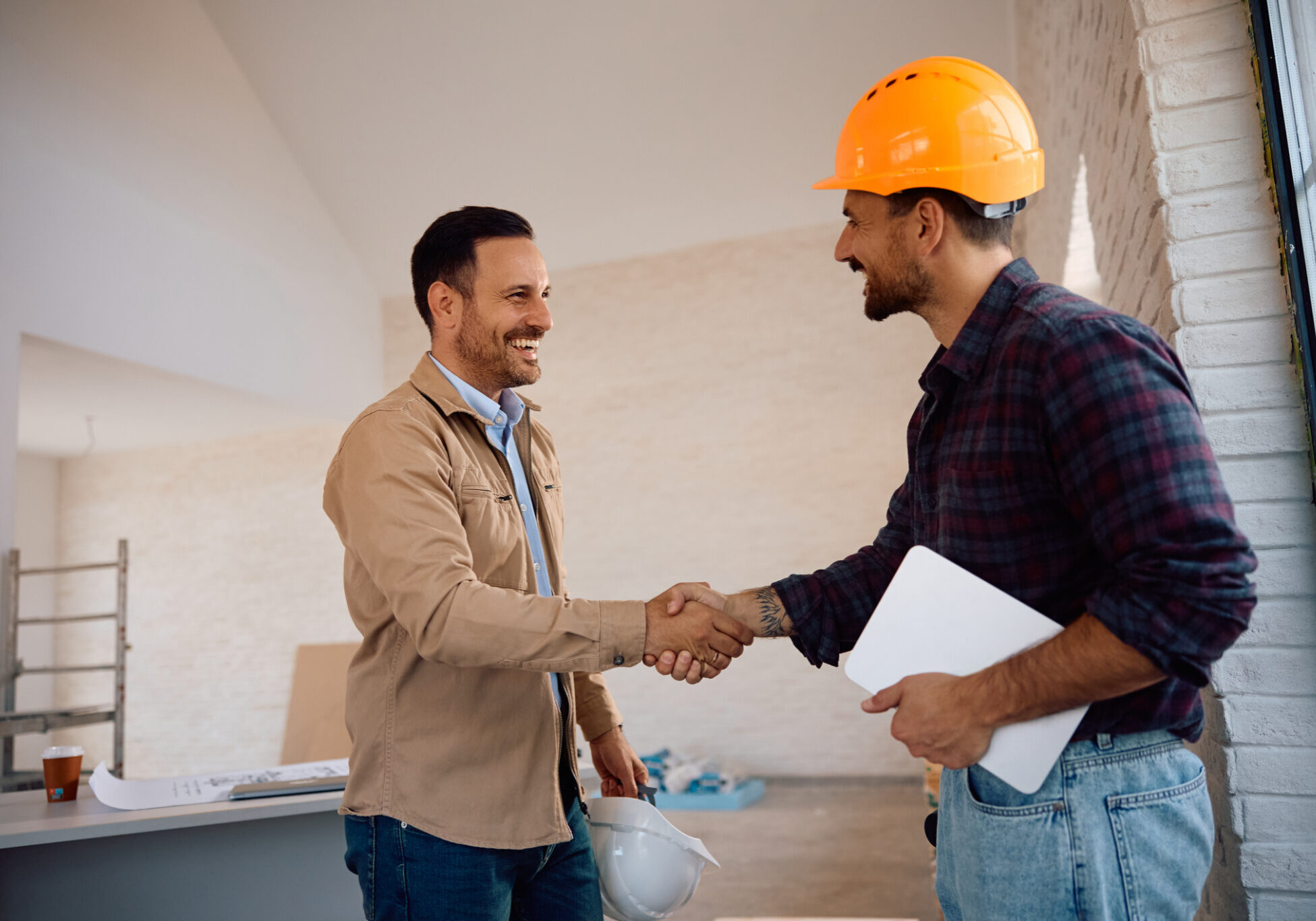 Construction workers shaking hands in agreement