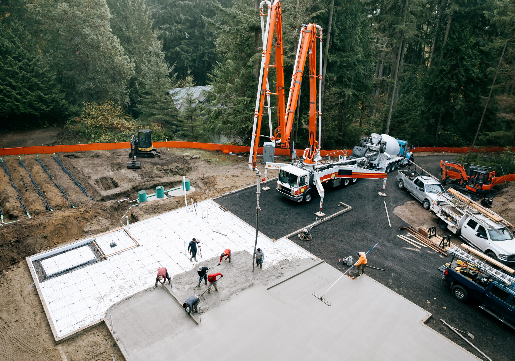 Construction workers pouring concrete slab