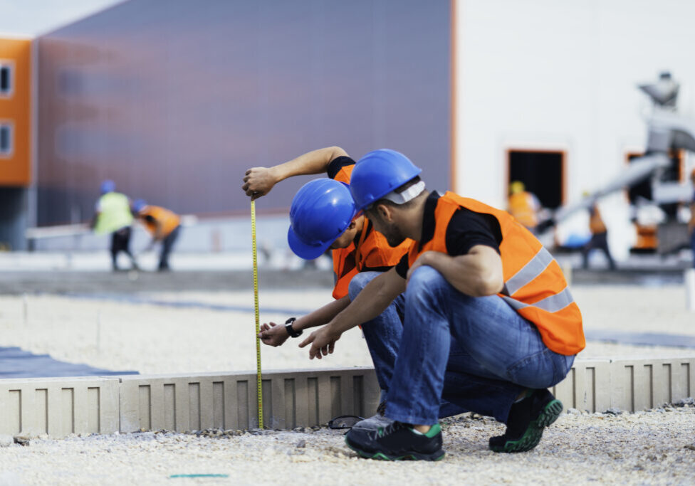 Team measuring for construction project
