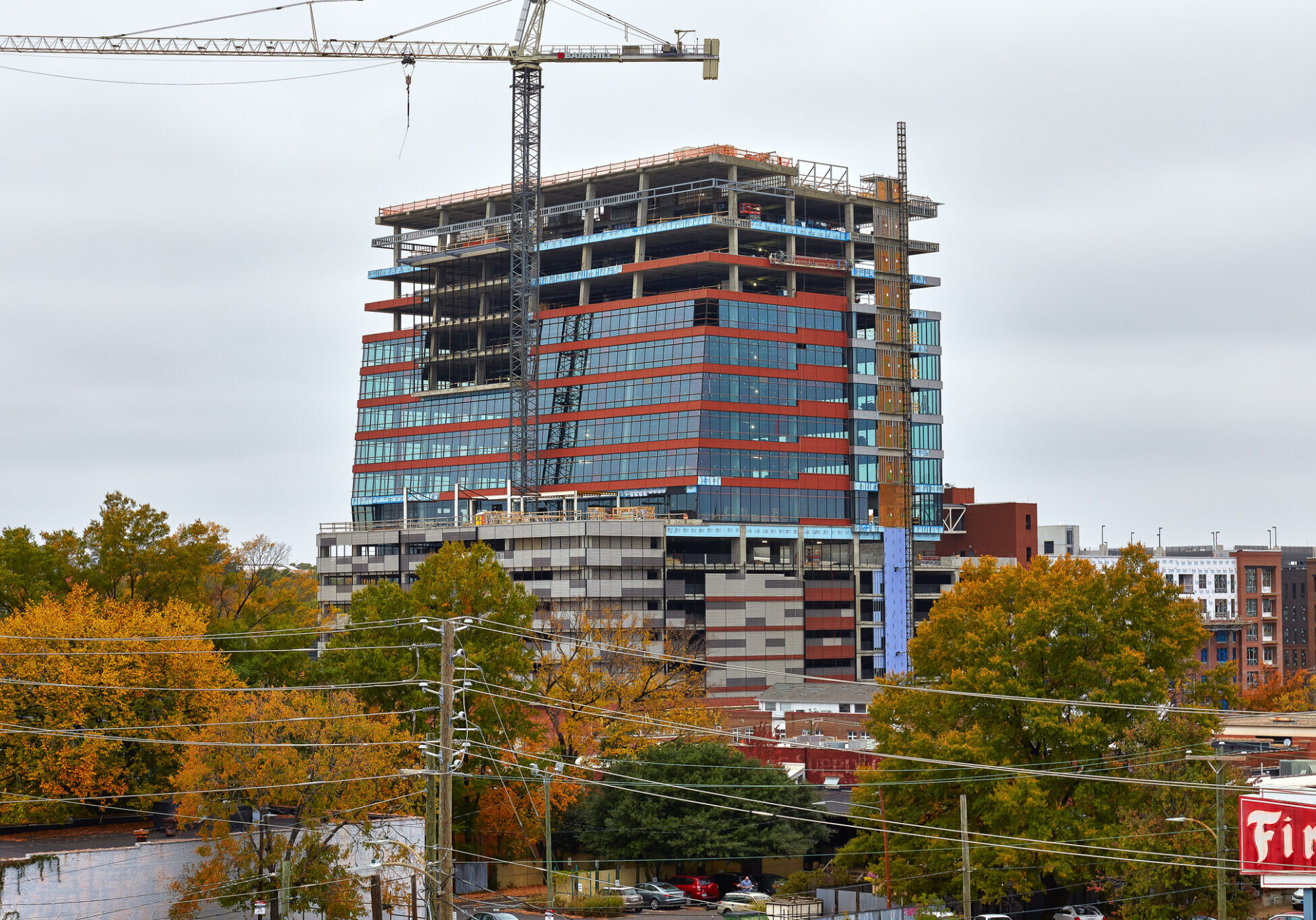 Urban development with cranes and autumn trees